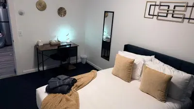 a bedroom with a bed with a blanket on it at Nona - Cozy 3BR Apt with Parking, Desk & Fast WiFi near Yale, Quinnipiac, SCSU & Hospitals in Hamden