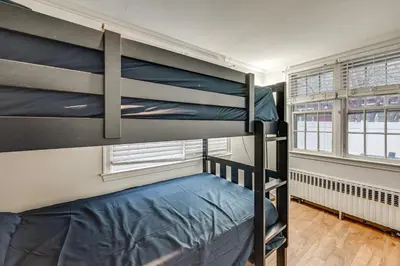 a bedroom with two bunk beds and a window at 1 Mi to Connecticut River Home with Large Backyard in Glastonbury