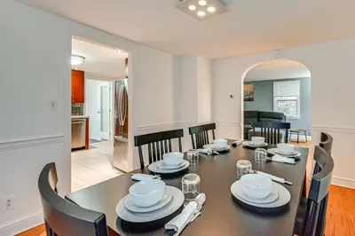 a dining room and living room with a table and chairs at 1 Mi to Connecticut River Home with Large Backyard in Glastonbury