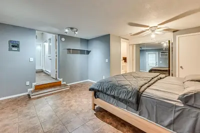 a bedroom with a bed and a ceiling fan at 1 Mi to Connecticut River Home with Large Backyard in Glastonbury