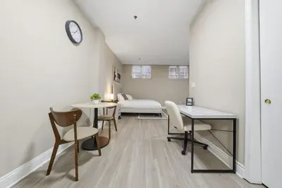 a room with a bed and a table and chairs at Chic Studio Retreat in New Haven in New Haven