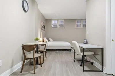 a room with a bed and a table and chairs at Chic Studio Retreat in New Haven in New Haven