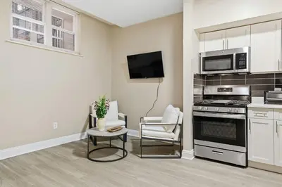 a kitchen with a stove and a microwave at Chic Studio Retreat in New Haven in New Haven