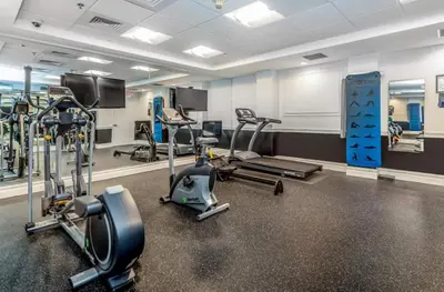 a gym with several treadmills and cardio machines at Modern 1BR perfect for extended visits in New Haven