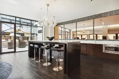 a kitchen with a large island with bar stools at FiDi Studio with Work Setup by Anyplace - 8827 in New York