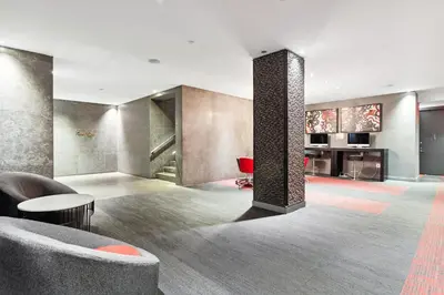 a living room with a couch and a column at FiDi Studio w Work Setup by Anyplace - 10250 in New York