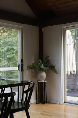 a dining room with a table and a window at Secluded escape with hot tub, pizza oven, fireplace in Taghkanic