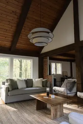 a living room with a couch and a table at Secluded escape with hot tub, pizza oven, fireplace in Taghkanic