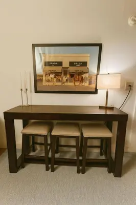 a wooden table with two chairs and a mirror at Elegant Upper East Side Studio Retreat Near Central Park and The Met in New York