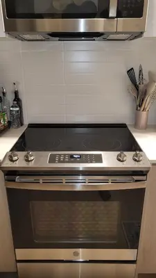 a stove top oven sitting in a kitchen at Elegant Upper East Side Studio Retreat Near Central Park and The Met in New York