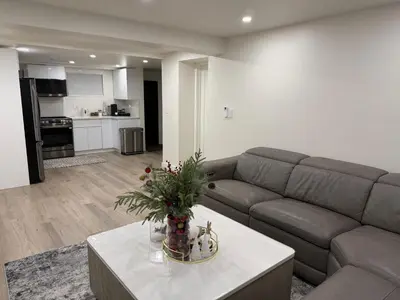 a living room with a couch and a table at Pelham parkway North in Baychester