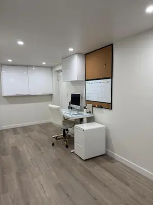 an office with a desk and a computer on a wall at Pelham parkway North in Baychester