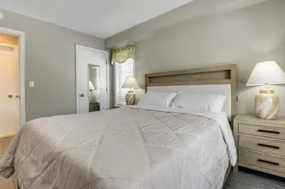 a bedroom with a large bed and two lamps at Walk to Mt Snow Ski Shuttle! Condo with Resort Perks in West Dover