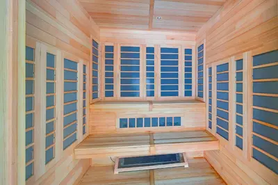 a sauna with wooden walls and wooden floors and windows at Walk to Mt Snow Ski Shuttle! Condo with Resort Perks in West Dover