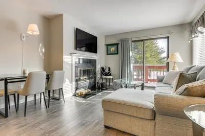 a living room with a couch and a table at Walk to Mt Snow Ski Shuttle! Condo with Resort Perks in West Dover