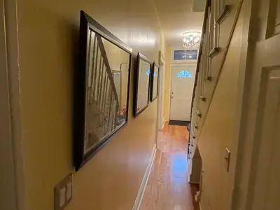 a hallway with a row of pictures on the wall at Downtown 3BR duplex full kitchen parking off i-787 in Albany