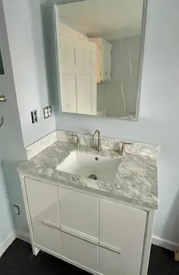 a bathroom with a sink and a mirror at Downtown 3BR duplex full kitchen parking off i-787 in Albany