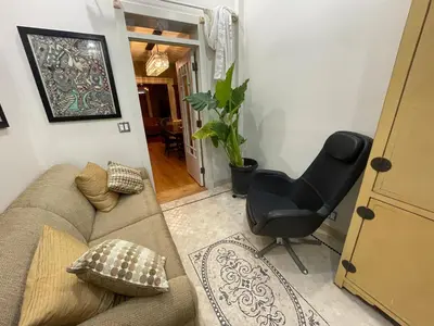 a living room with a couch and a chair at Downtown 3BR duplex full kitchen parking off i-787 in Albany