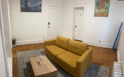 a living room with a couch and a coffee table at Maison Mae Pillars in Mount Vernon