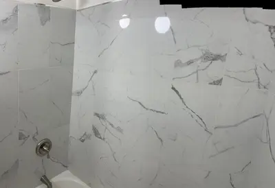 a bathroom with white marble walls and a shower at Maison Mae Pillars in Mount Vernon