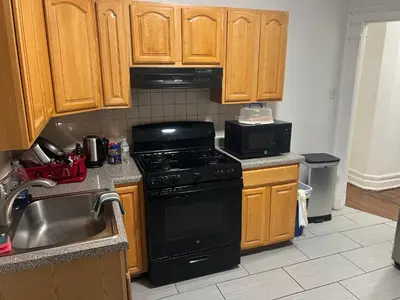 a kitchen with wooden cabinets and a stove and a sink at Maison Mae Pillars in Mount Vernon