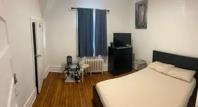 a bedroom with a bed and a television in it at Maison Mae Pillars in Mount Vernon