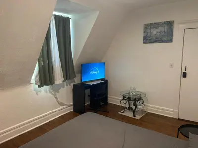 a bedroom with a bed and a tv on a table at Maison Mae Pillars in Mount Vernon
