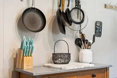 a kitchen counter with pots and pans and utensils at Little Longbow Lakefront Chalet in Becket