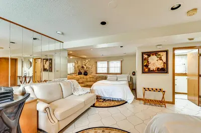 a living room with a couch and a bed at Spacious Yard with Gazebo Charming Windsor Retreat in Windsor
