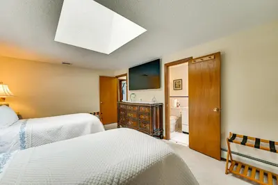 a bedroom with two beds and a bathroom at Spacious Yard with Gazebo Charming Windsor Retreat in Windsor