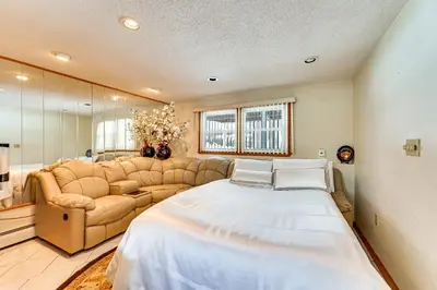 a large bedroom with a large bed and a couch at Spacious Yard with Gazebo Charming Windsor Retreat in Windsor
