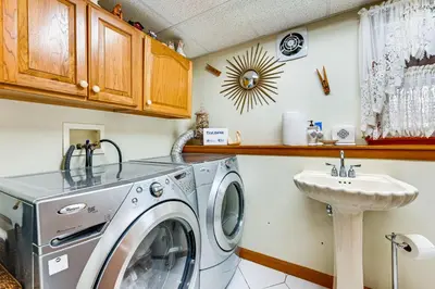 a laundry room with a washing machine and a sink at Spacious Yard with Gazebo Charming Windsor Retreat in Windsor