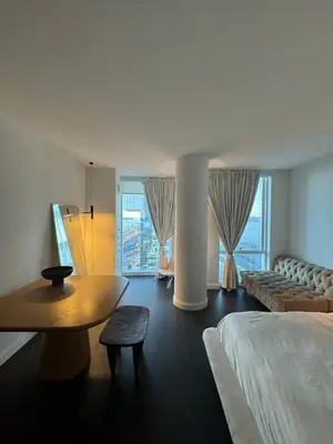 a bedroom with a bed and a table and a couch at Hudson River - Lincoln Center in New York