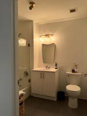 a bathroom with a toilet and a sink and a mirror at Hudson River - Lincoln Center in New York