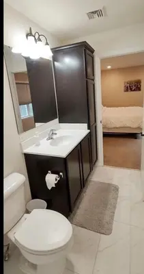 a bathroom with a white toilet and a sink at Luxury Townhouse Near West Point in Highland Falls