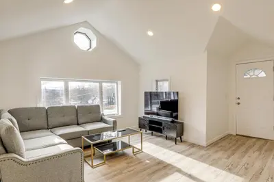 a living room with a couch and a tv at Home with Lake Views and Deck in New Jersey Highlands! in Stanhope