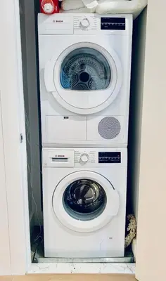 a washing machine and a dryer in a room at Stylish Williamsburg One Bedroom Condo Near Manhattan in Brooklyn