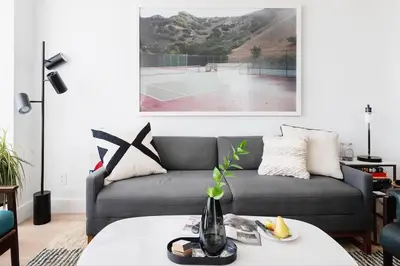 a living room with a couch and a tennis court at Stylish Williamsburg One Bedroom Condo Near Manhattan in Brooklyn