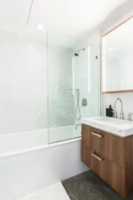 a bathroom with a shower and a sink at Stylish Williamsburg One Bedroom Condo Near Manhattan in Brooklyn