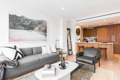 a living room with a couch and a chair at Stylish Williamsburg One Bedroom Condo Near Manhattan in Brooklyn