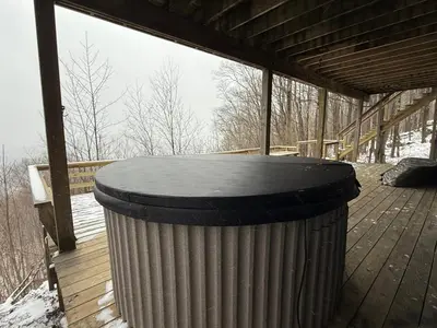 a trash can sitting on a deck in the snow at Serene 4-bedroom chalet in charming Catskills awaits you- amazing Mountain Views in Bovina Center