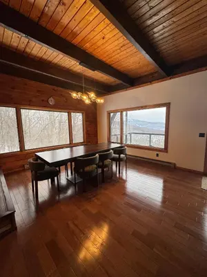 a large dining room with a table and chairs at Serene 4-bedroom chalet in charming Catskills awaits you- amazing Mountain Views in Bovina Center