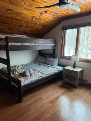 a bedroom with a bunk bed and a wooden ceiling at Serene 4-bedroom chalet in charming Catskills awaits you- amazing Mountain Views in Bovina Center