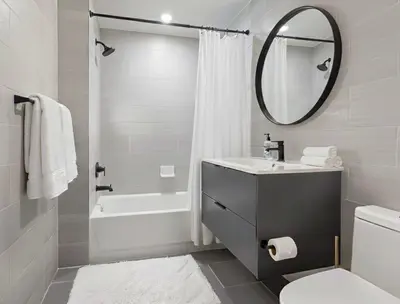 a white bathroom with a sink and a mirror at Charming Brooklyn Flat in Brooklyn