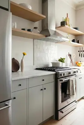 a kitchen with white cabinets and a stove top oven at Charming Brooklyn Flat in Brooklyn