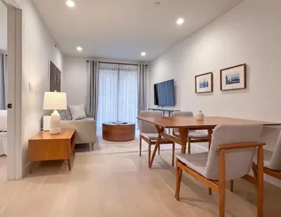 a living room with a dining room table and a couch at Charming Brooklyn Flat in Brooklyn