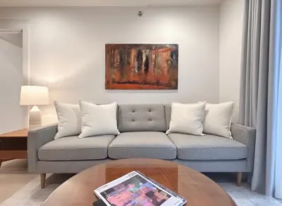 a living room with a couch and a painting on the wall at Charming Brooklyn Flat in Brooklyn