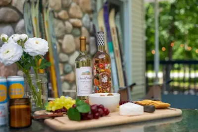 a bottle of wine sitting on top of a table with food at 4BDRM Games Family Frndly Fire Pit Masthope in Lackawaxen