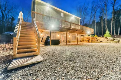a house with a staircase leading up to it at 6 Bedrooms Hot Tub Game Room Movie Theater in Hawley
