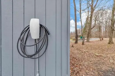 a security camera on the side of a building at Lakefront Hot Tub Kayaks High End Peaceful in Tobyhanna